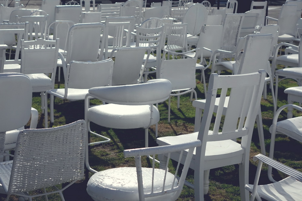 185 empty white chairs